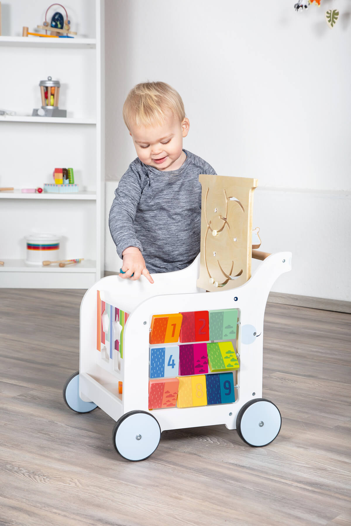 Child walking with deluxe wooden baby walker